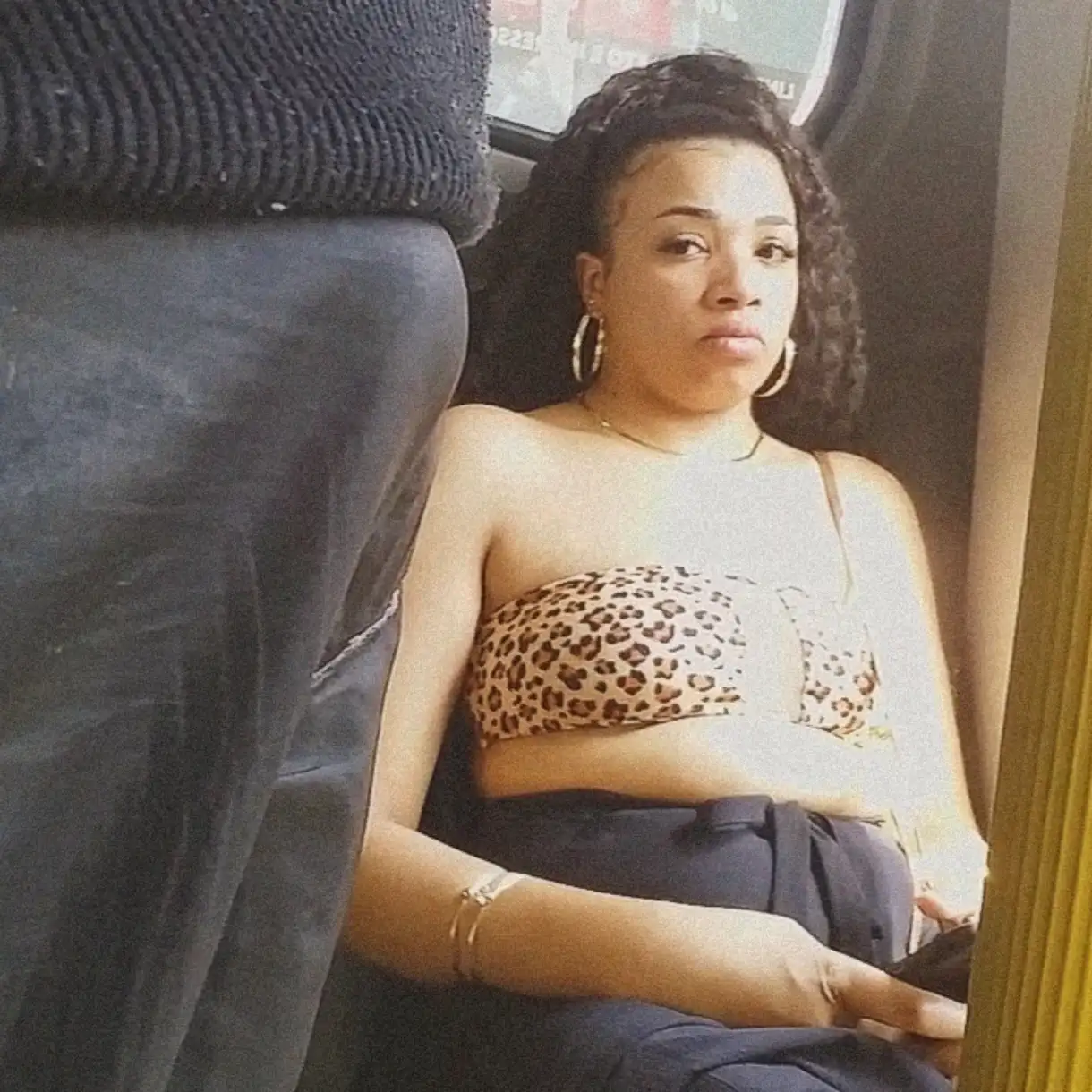 Brazilian brunette looking at bulge on the bus