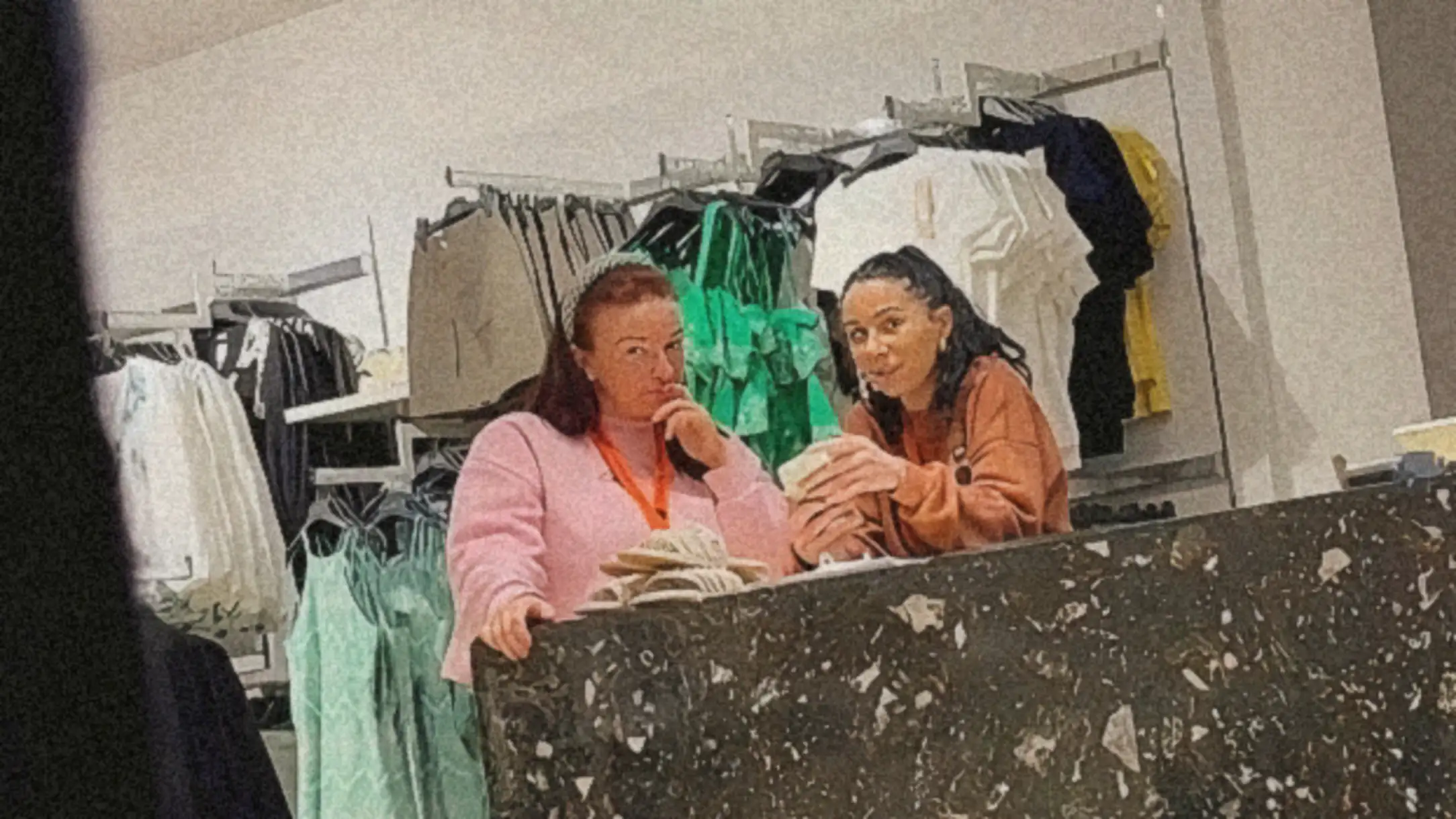 Store saleswomen looking at customer bulge flash