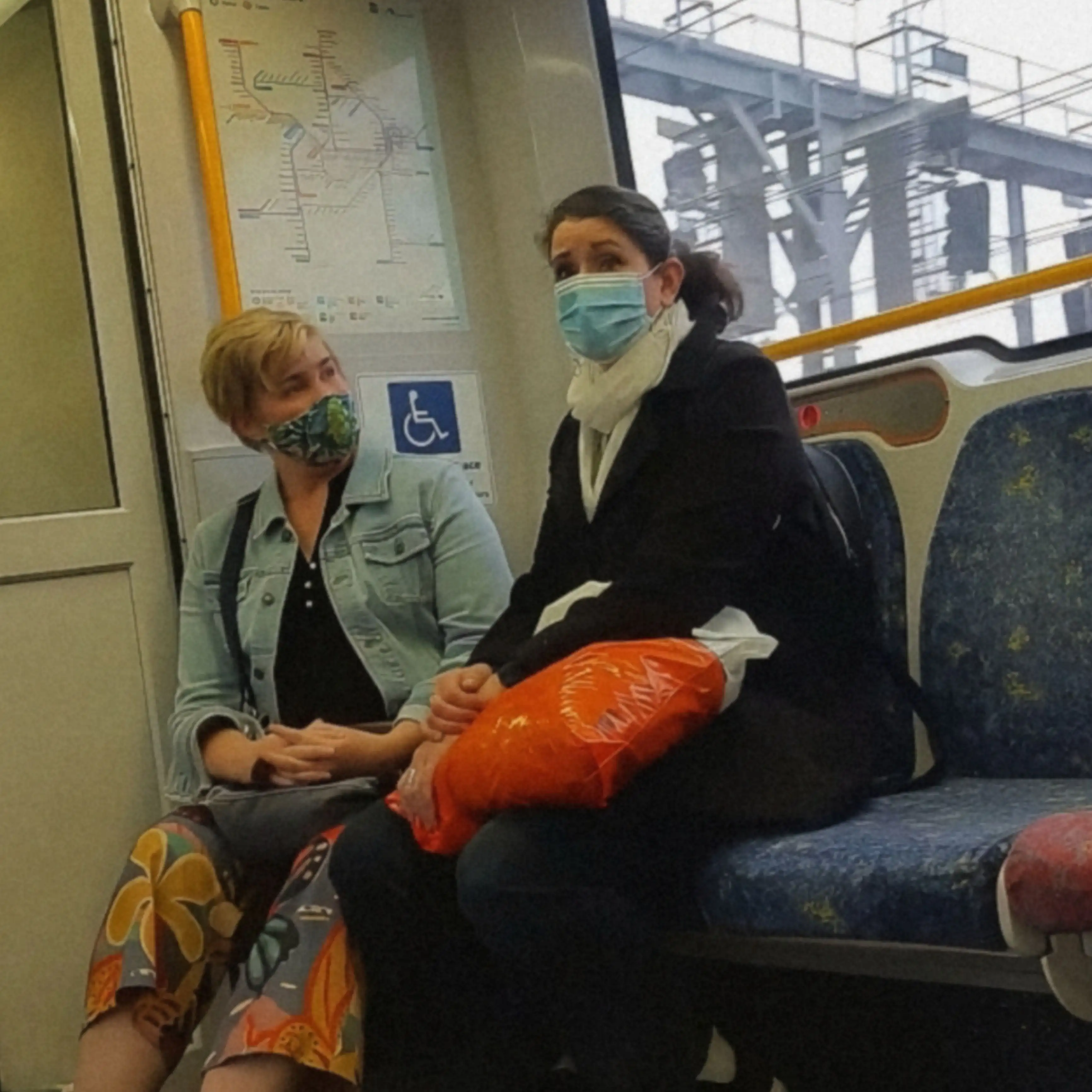 Two mature women looking at the bulge on the train