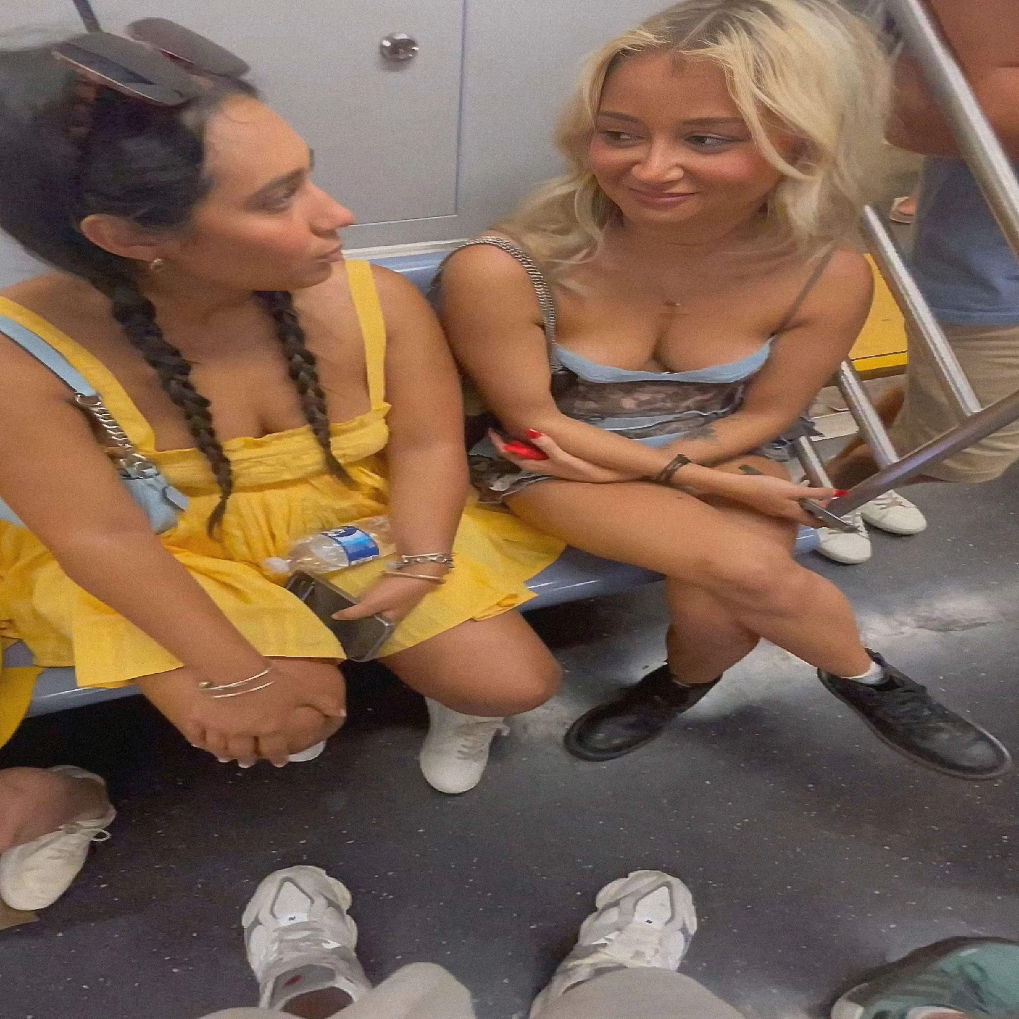 Hot blonde and her friend looking at bulge on the train