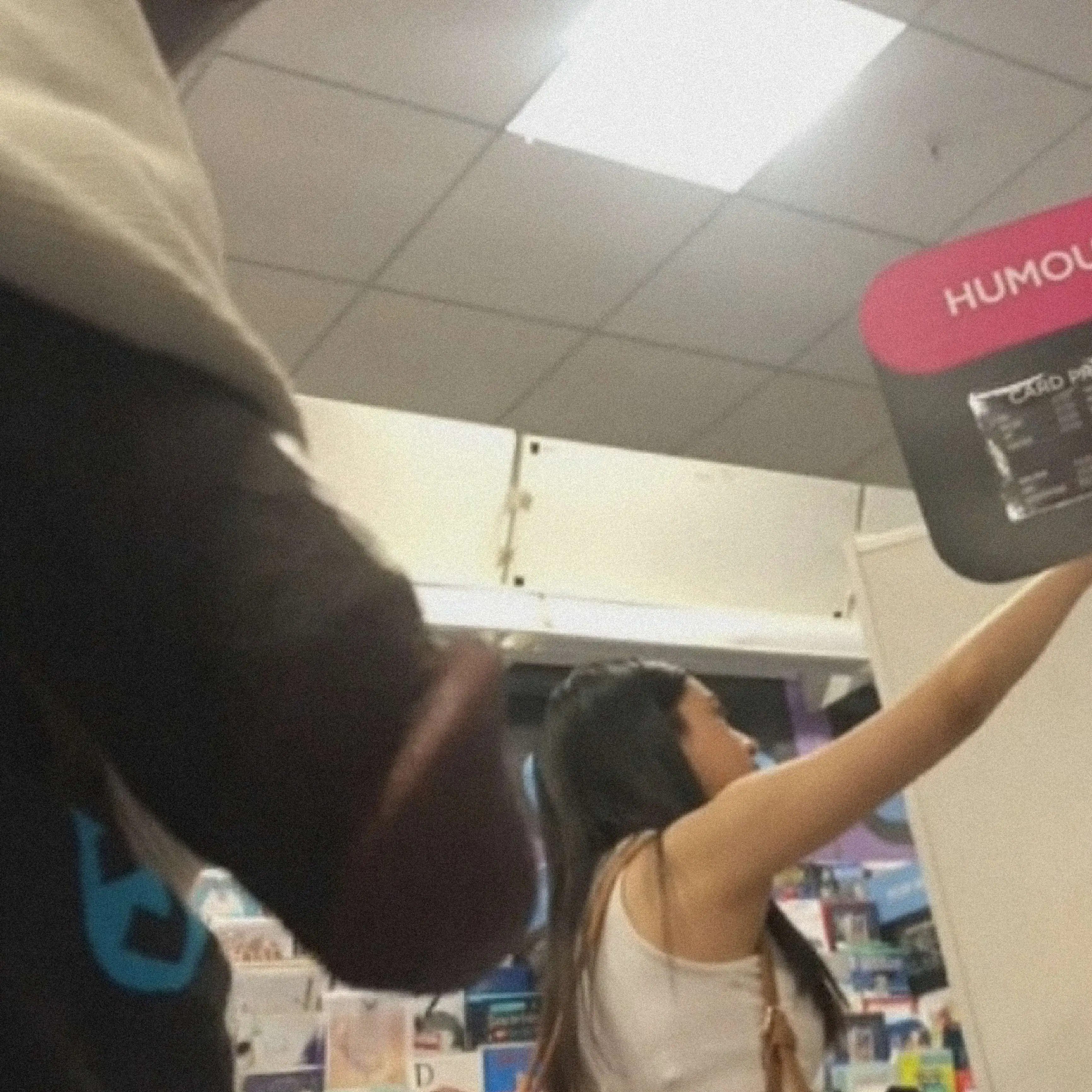 Hot teen checking out the products at the store
