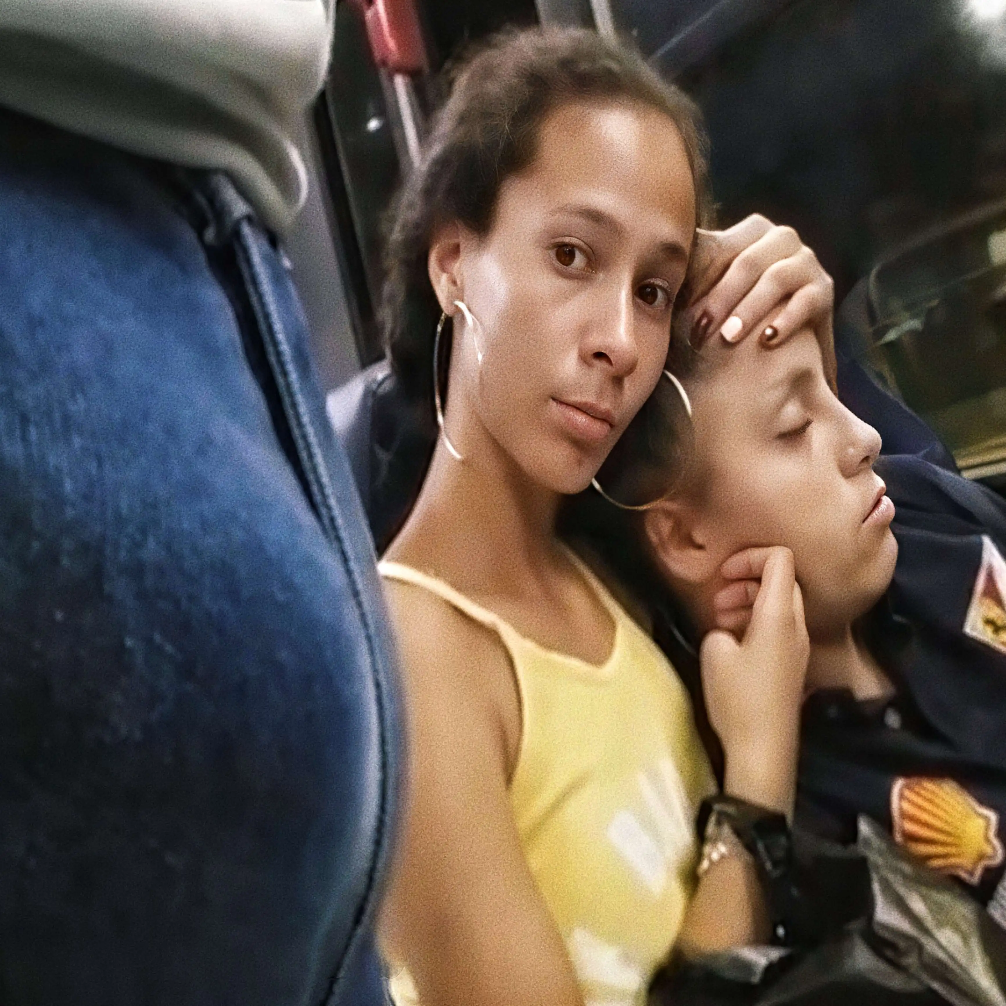 Brazilian mother with daughter looking at bulge on the bus