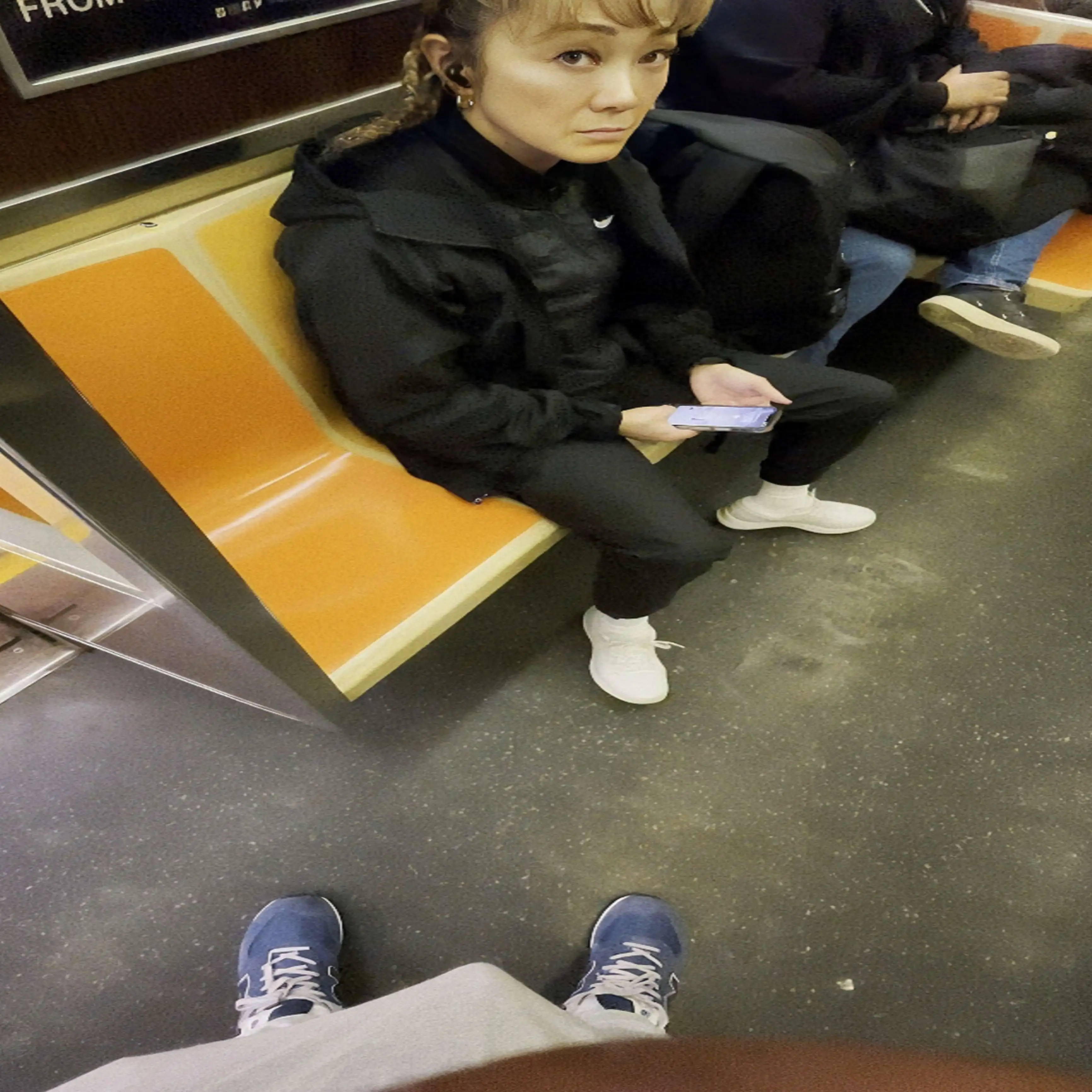 Mature Asian looking at bulge on train