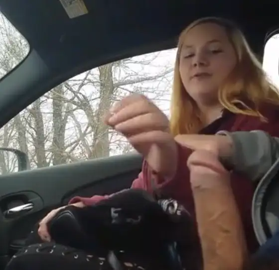 Shy young girl cheating on her boyfriend, giving a handjob in the car.