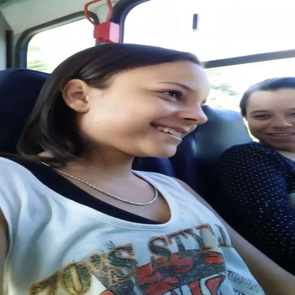 Cute teen and her friend looking at the bulge on the bus