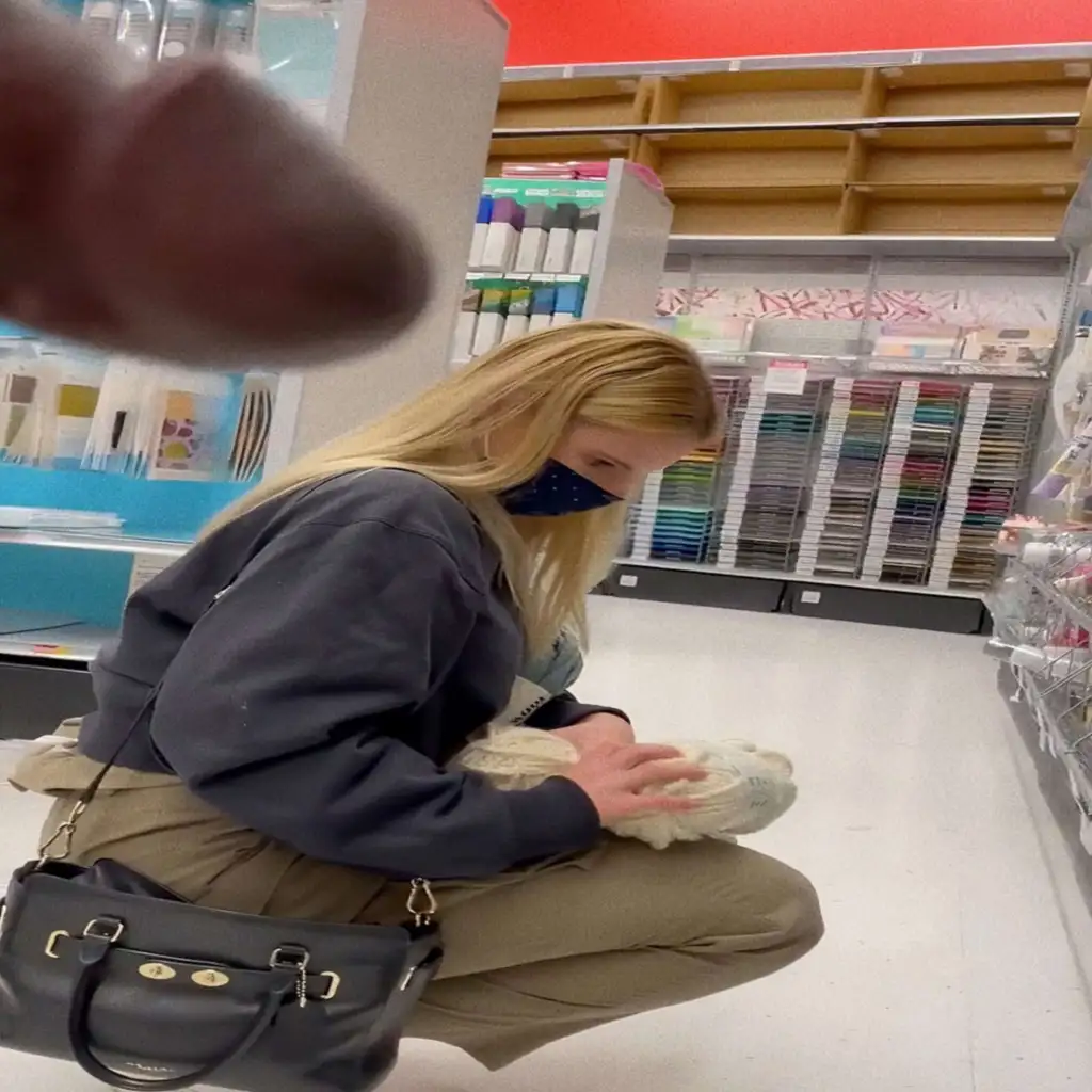 Hot blonde looking at the products in the store