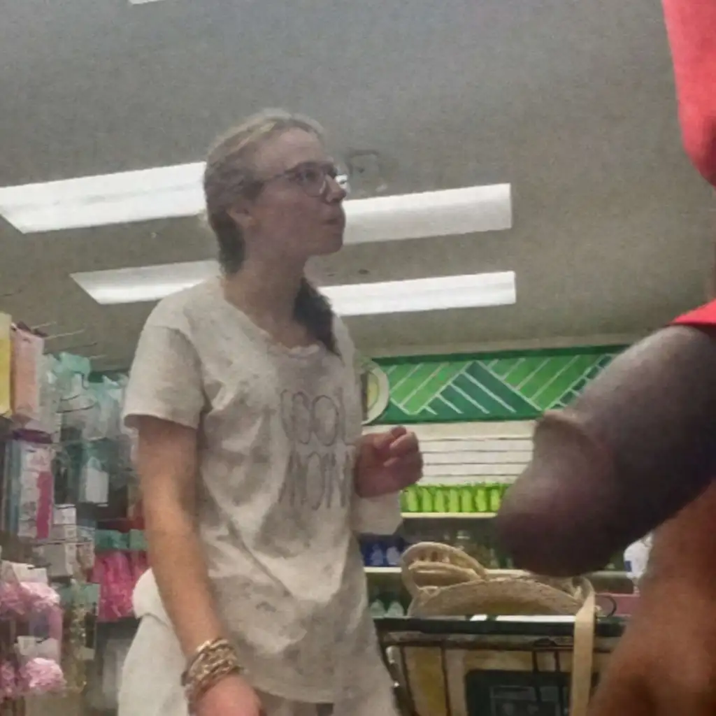 Cute nerdy blonde looking at products in the store