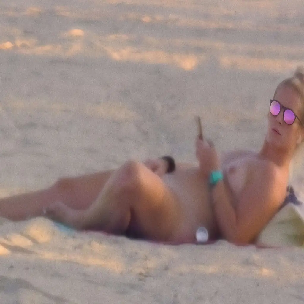 Hot blonde masturbating on the beach