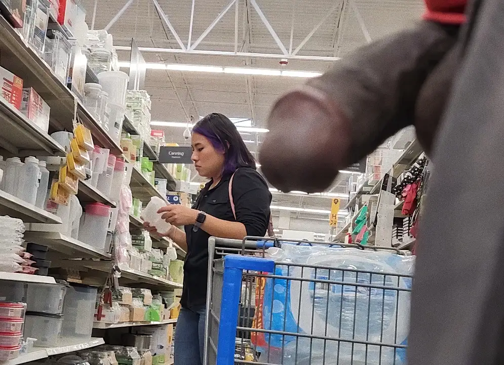 Hot young goth girl with purple hair in the store