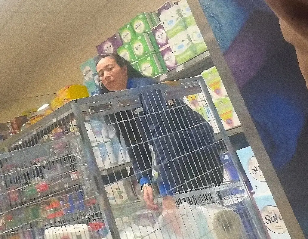 Sexy Asian store employee looking bulge flash at customer