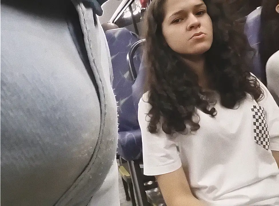 Sexy Brazilian girl looking at her bulge on the bus
