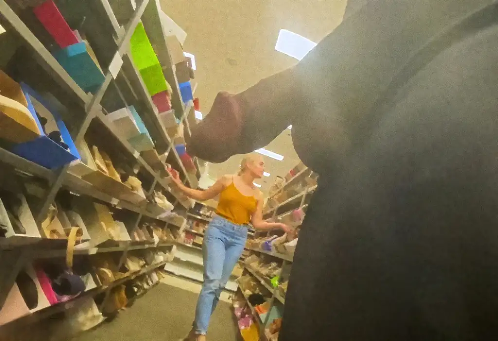 Hot blonde looking at shoes in the store