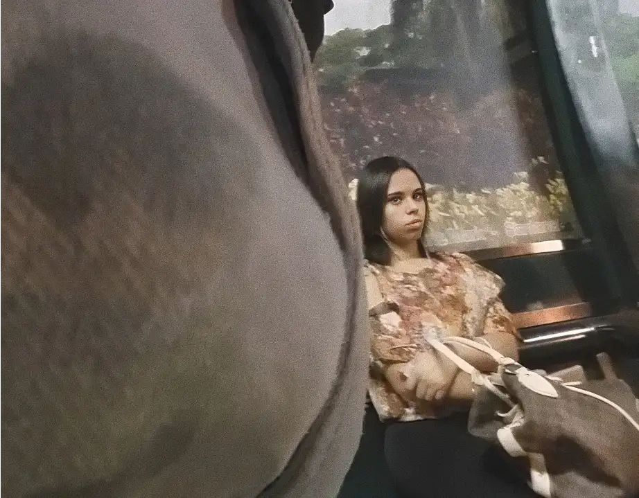 Sexy Brazilian brunette looking at her bulge at the bus stop
