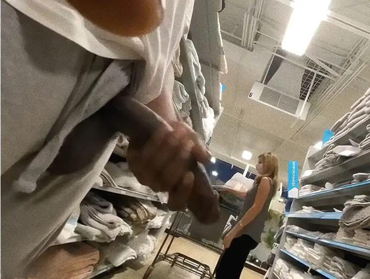 Mature blonde looking at the products and giant black dick on the side