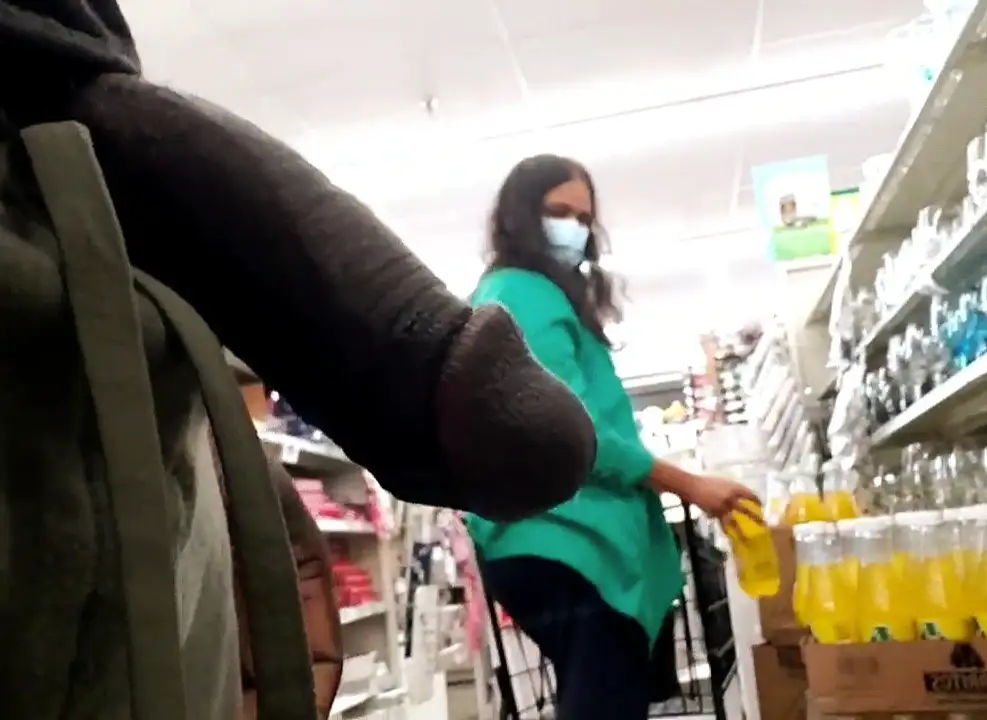 Hot MILF looking at black dick in the store
