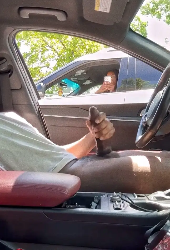 Slut taking a picture of her giant dick in the parking lot, she'll use it later