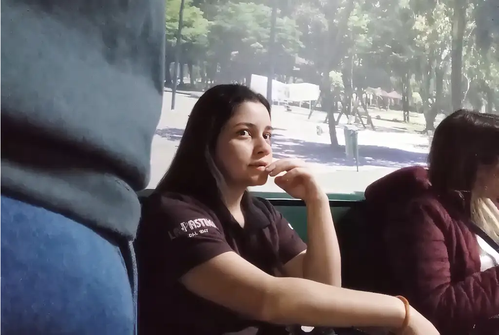 Brazilian woman looking at bulge at bus stop