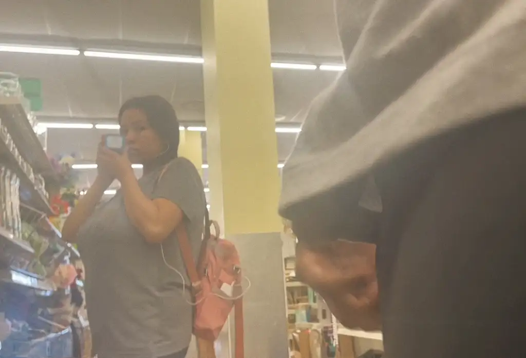 Hot Latina with big tits looking at big black dick in the store