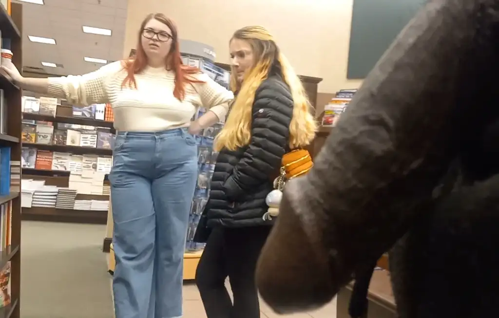 Beautiful friends chatting in the library