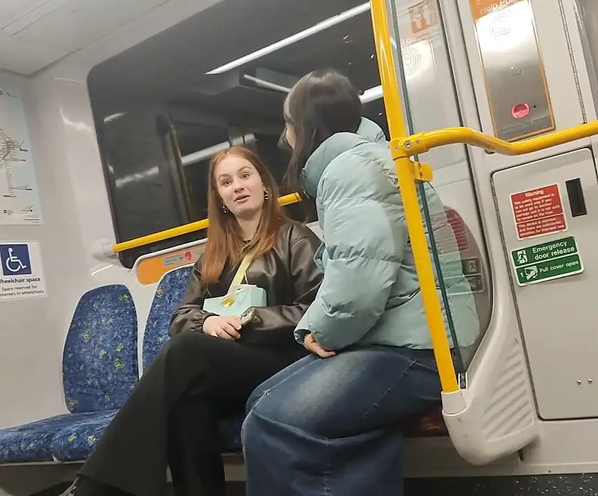 Naughty friends looking at bulges on the train