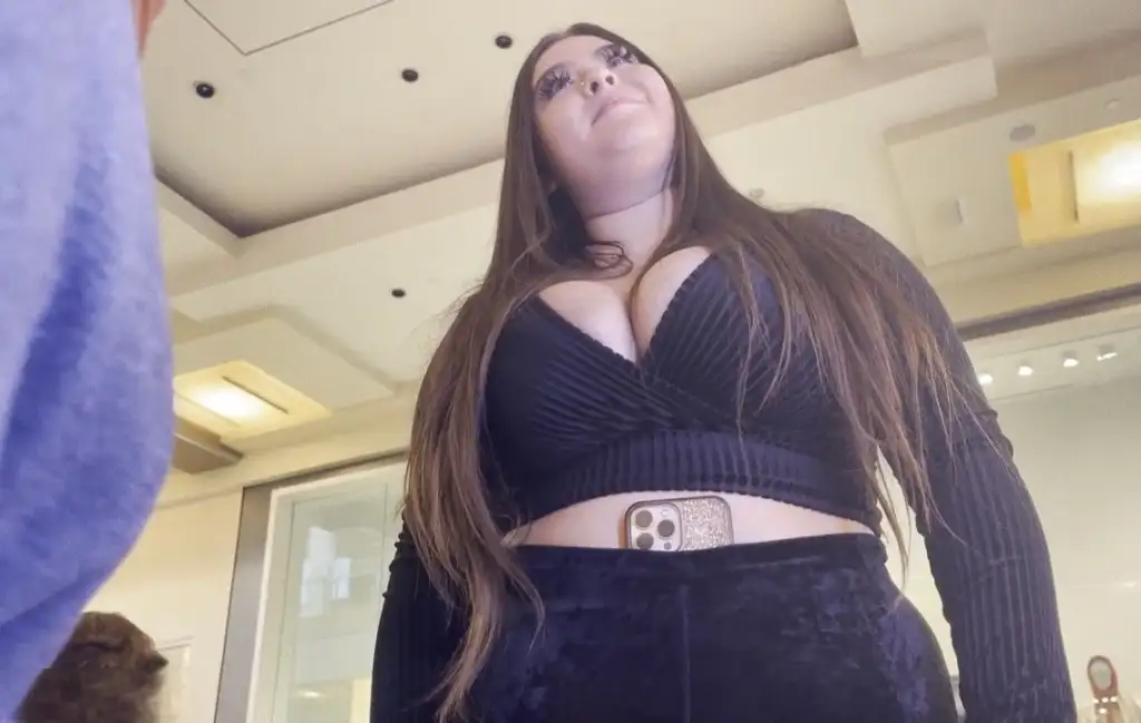 Hot Latin saleswoman in love and looking at the bulge of the customer