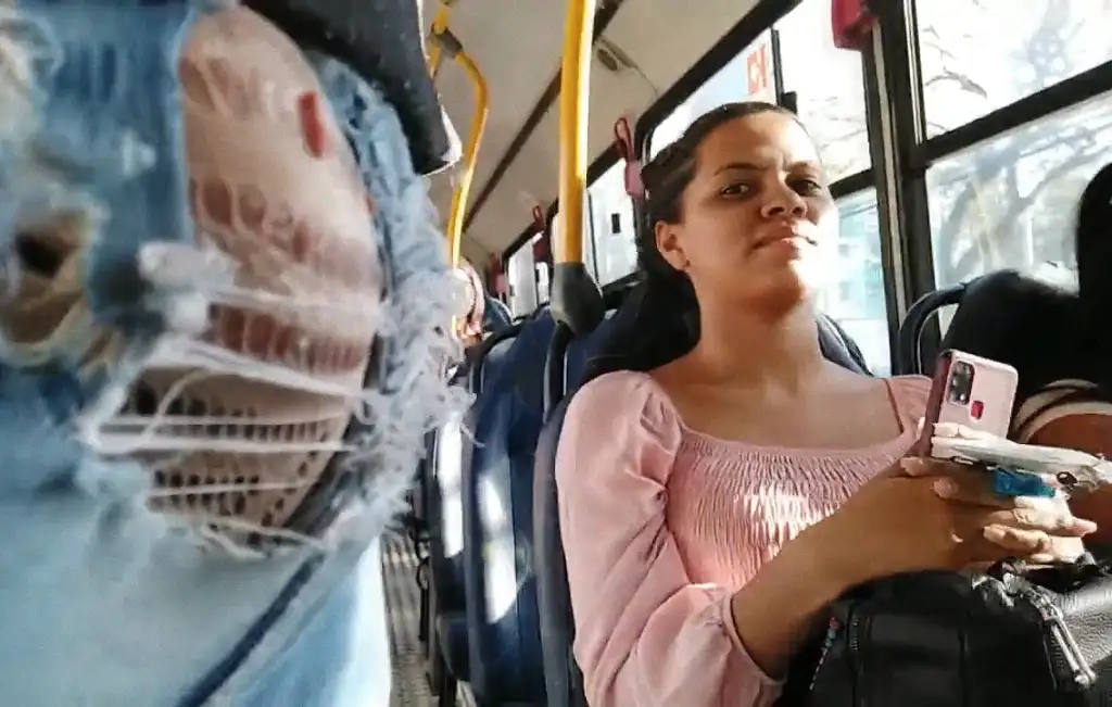 Brazilian brunette looking at a bulge on the bus