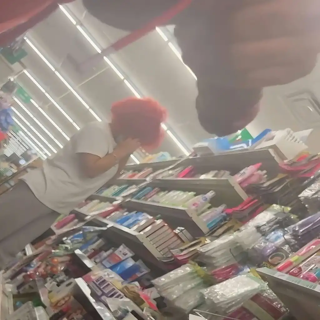 Redhead lesbian talking on the phone with girlfriend in store