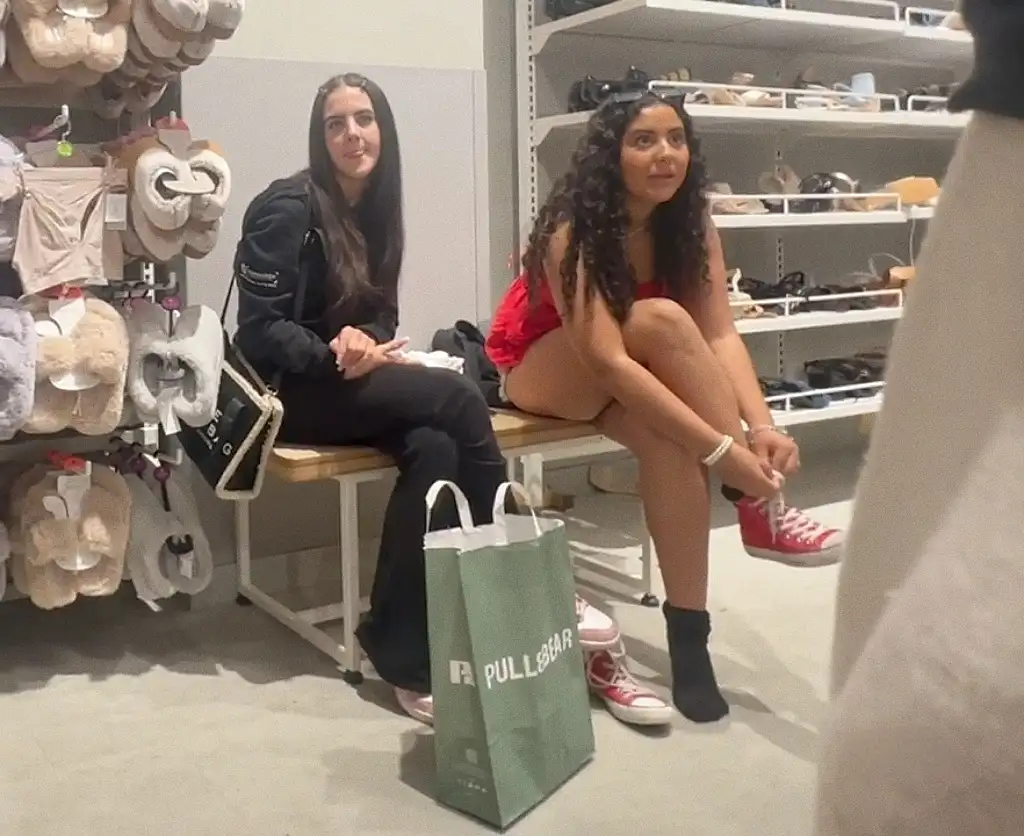 Smiling sexy teens friends looking at dick in shop