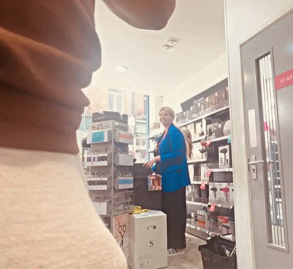 Smiling saleswomen looking at bulge in store