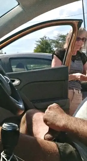 Mature handing a paper towel to a stranger in the parking lot