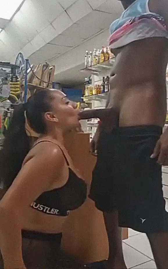 Hot brunette sucking a huge black cock in the store