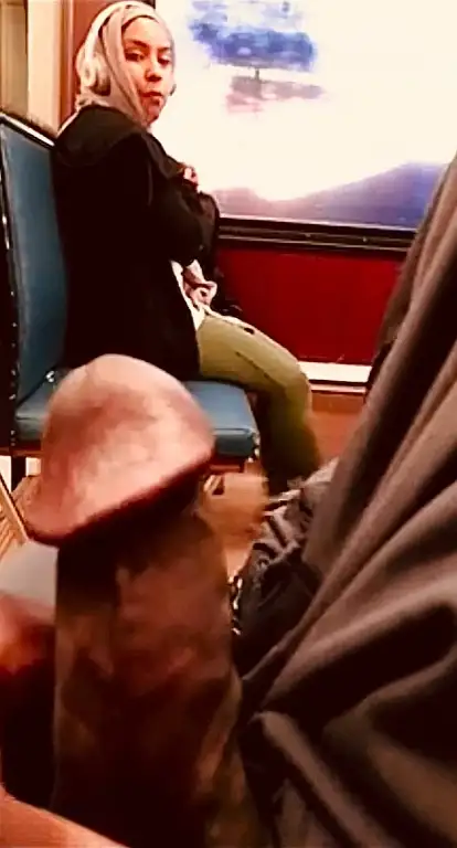 Hijab looking at the huge black cock on the train