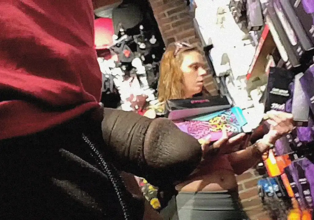 Hot girl with a belly button piercing looking at products in the store