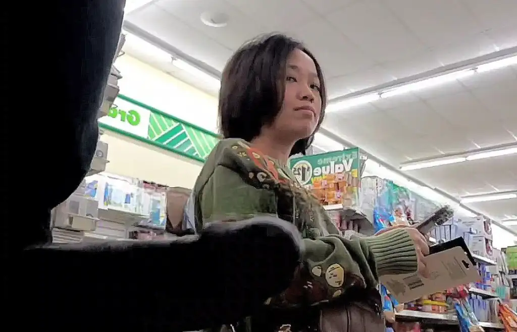 Sexy Japanese girl looking at black cock in store