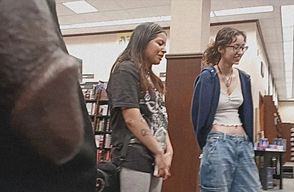 Two hot friends in the library, one of them looked at the black cock
