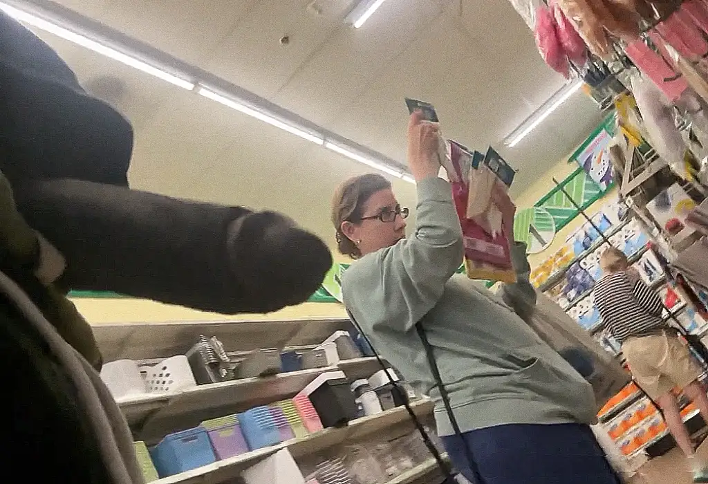 Hot MILF looking at products in the store