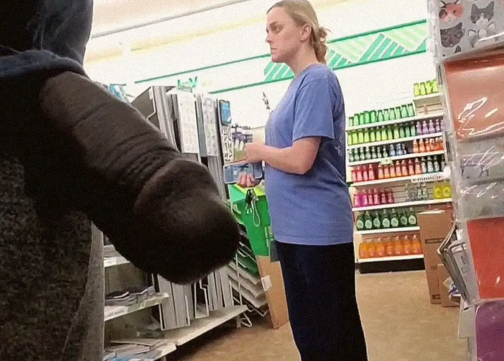 Slightly suspicious blonde looking at products in the store