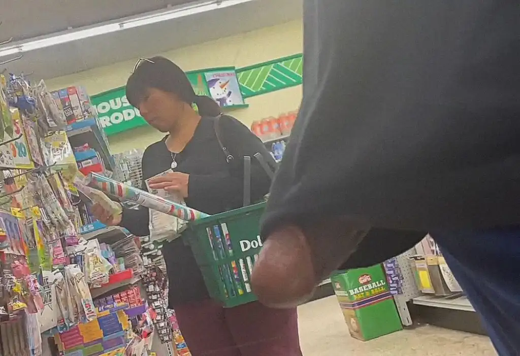 Latina brunette bangs looking at products in the store