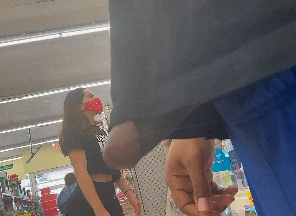 Hot brunette looking at products in the store