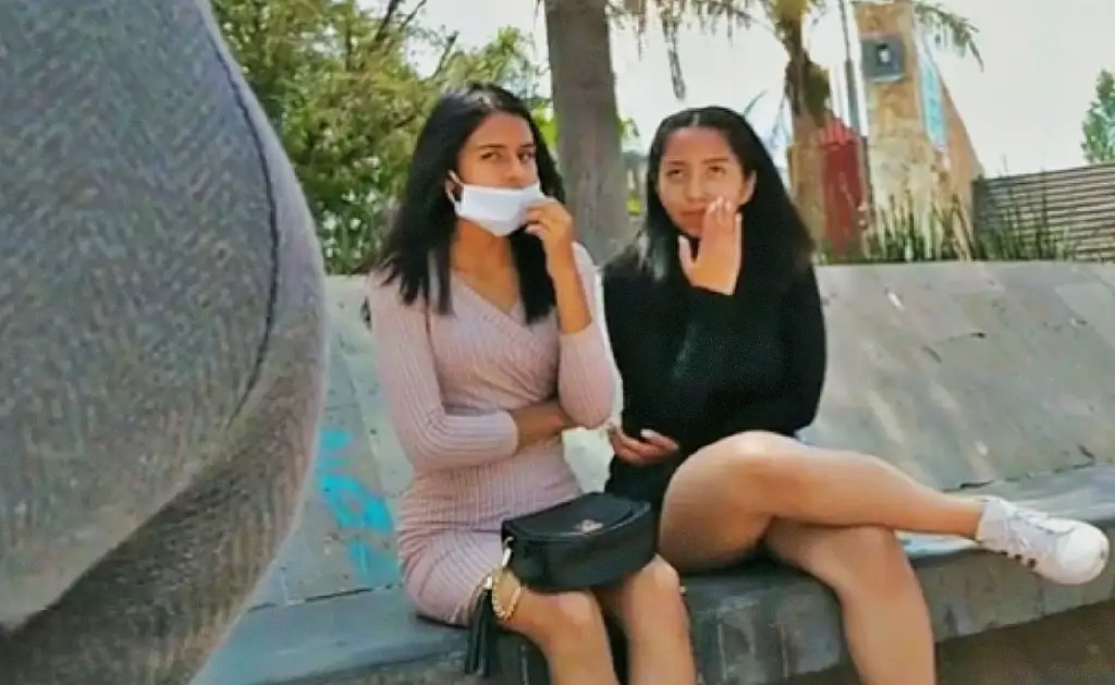 Two Latina teens checking out the bulge at the bus stop, they loved it