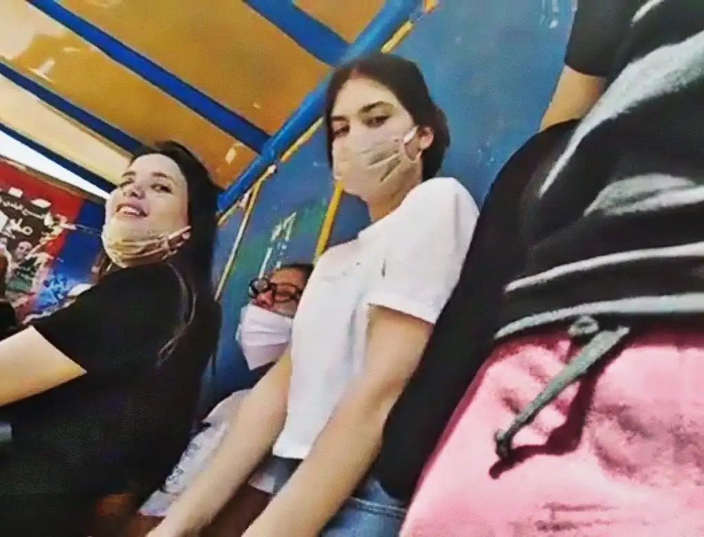 Three student friends checking out a bulge at the bus stop, they loved it