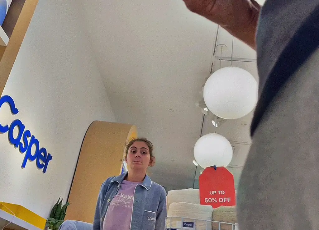 Shy sexy saleswoman looking at bulge